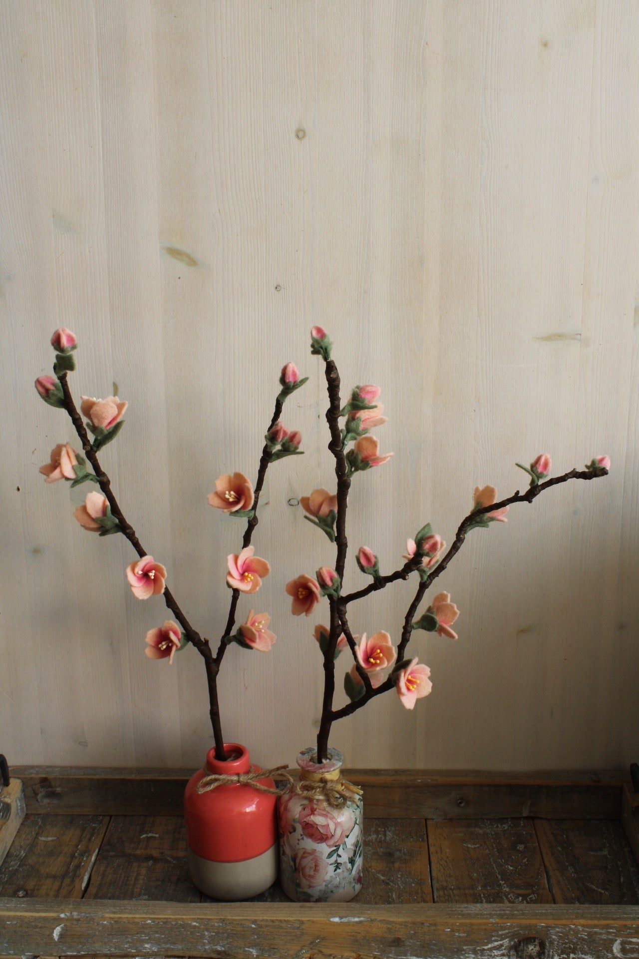 Twee kleine handgemaakte  bloesemtakjes met roze bloesem bloemetjes van vilt bevestigd op een echte tak, sakura, kersenbloesem